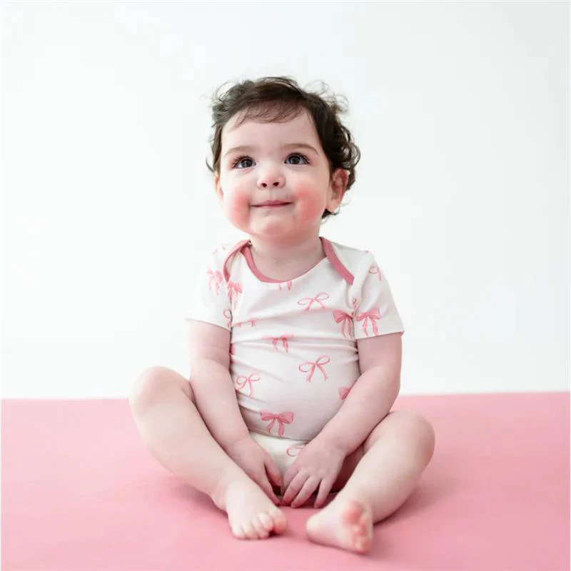 Kyte Baby Bodysuit In Bow